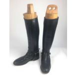 Pair of black leather hunting boots with wooden trees, size 12L
