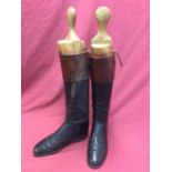 Pair of gentleman's black leather hunting boots with brown tops and wooden trees by Peal & Co. Ltd.