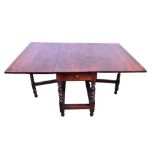 Large early 18th century walnut drop leaf dining table