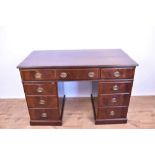 Edwardian mahogany twin pedestal desk with an arrangement of nine drawers and oval brass handles