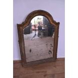 Gilt gesso wall mirror, pleasantly distressed plate of arched form, in pierced and scroll moulded fr