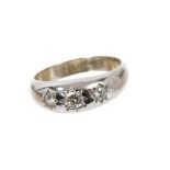 Diamond three stone ring with three brilliant cut diamonds in gypsy style 18ct white gold setting, e