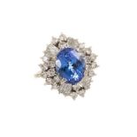 Tanzanite and diamond cluster cocktail ring with an oval mixed cut blue sapphire measuring approxima