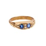 Edwardian sapphire and diamond ring with two oval mixed cut blue sapphires interspaced by rose cut d