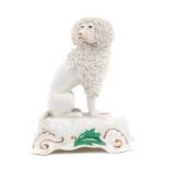 A Staffordshire porcelain inkwell, in the form of a seated poodle, circa 1840