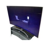 75" Qled Curved Samsung TV together with Stand and remote control. Television currently turns on but