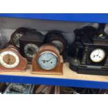 Two large slate mantel clocks, together with a group of other mantel clocks