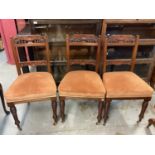 Set of six Edwardian dining chairs with padded seats on turned front legs, together with another sim