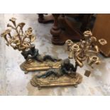 Pair of cast metal candelabra with reclining man on decorative plinth bases, 60 cm high x 55 cm long