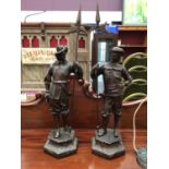 A pair of bronzed figures of cavaliers, signed Winslow, 68cm high