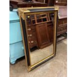 Bevelled wall mirror in gilt and black frame, 79cm x 110cm