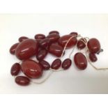 Two vintage simulated cherry amber bead necklaces (all loose)