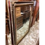 Large bevelled wall mirror in gilt and black frame