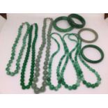 Six contemporary green hard stone polished bead necklaces and four green hard stone bangles