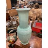 Chinese celadon glazed vase with character marks to base.