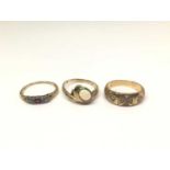 Three 14ct gold rings to include a diamond and ruby ring, opal single stone ring and one other ring