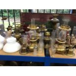 Collection of brass oil lamps and glass shades, a model ship, etc