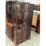 1930's carved oak bookcase with shelved interior enclosed by two glazed doors with two further panel
