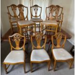 Georgian-style yew twin pedestal dining table with one extra leaf and eight matching chairs comprisi