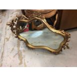 Four wooden framed wall mirrors