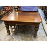 Victorian mahogany extending dining table with two extra leaves on turned legs and castors, opening