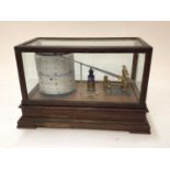 Cased barograph with engraved patent number 22556, 31cm across