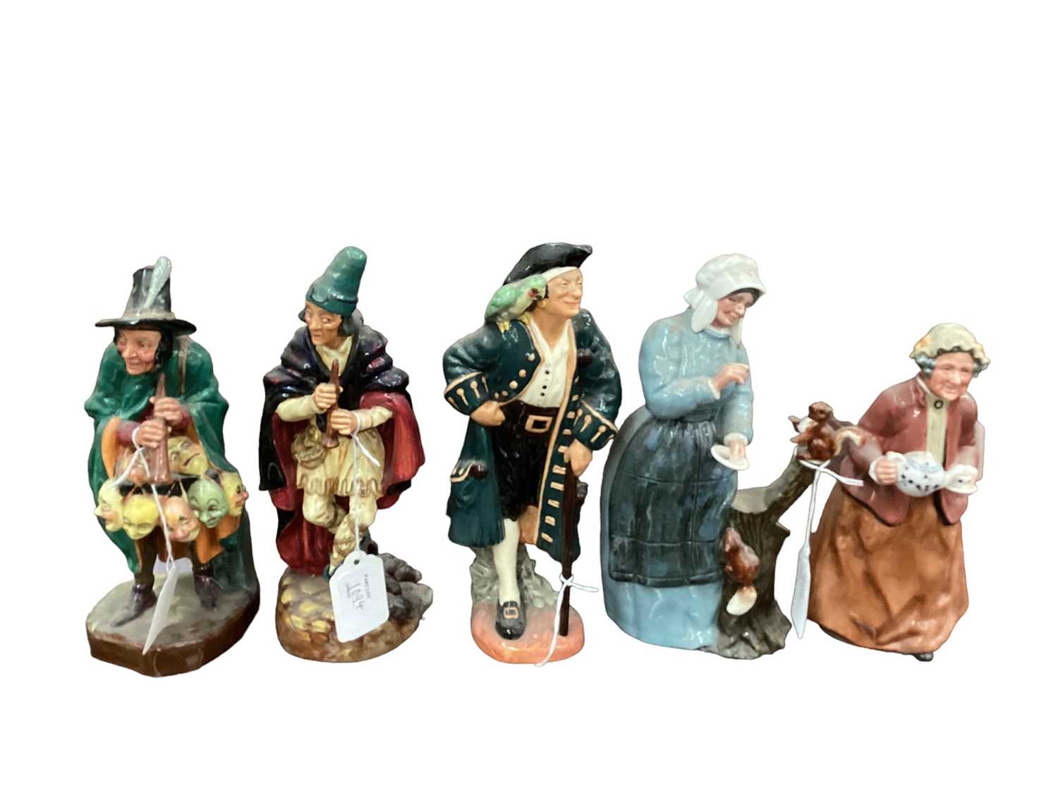Five Royal Doulton figures - The Mask Seller HN2103, The Pied Piper HN2102, Long John Silver HN2204,