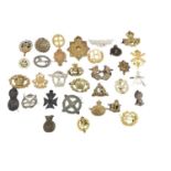 Collection of thirty two British Military cap badges, for various regiments including Royal Marines,