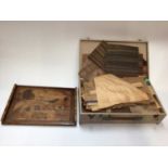 Group of furniture inlays in box together with a wooden tray