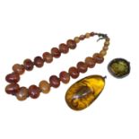Large reconstituted amber pendant with a scorpion inside, reconstituted amber brooch in white metal