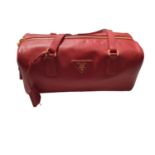 Prada saffiano red leather Bowling bag with padlock and key. Dimensions W.28cm, H. 15cm (not includ