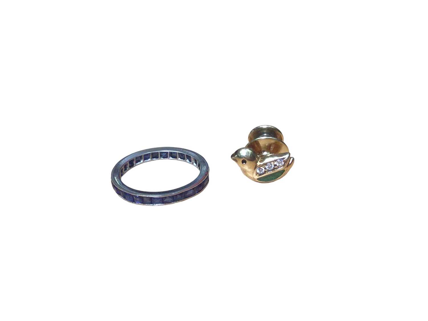Platinum and blue sapphire eternity ring and a gold (750) enamel and paste set novelty pin in the fo