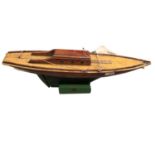 Wooden model yacht and stand.