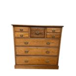 Edwardian blond oak chest of drawers, with central deep drawer and four short drawers, three long gr