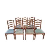 Set of seven early 20th century lined oak ladder back chairs, with two carvers