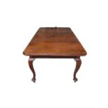 Edwardian extending mahogany dining table, with canted rectangular wind out top on cabriole legs and