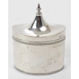 George V silver Arts and Crafts tea caddy of tall oval form with decorative floral borders