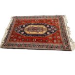 Persian design rug on red ground