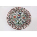 A Chinese famille verte dish, Kangxi period, decorated with birds and flowers, the outside panelled,