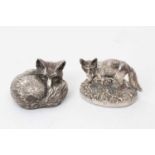 Two filled silver models of foxes