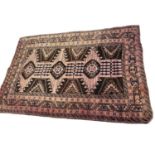 Baluch rug, with conjoined medallions on biscuit ground, 180 x 118cm