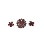 Georgian garnet cluster brooch and earrings, the flower shaped brooch with flat cut garnets in foil-