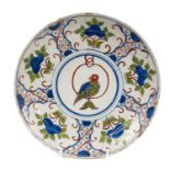 Unusual Delft saucer dish, circa 1740, painted with a parrot