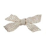 A fine 1920s diamond bow brooch, the stylised bow with pavé set old cut diamonds in platinum and 18c