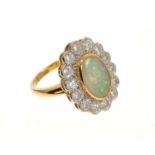 Opal and diamond cluster ring with an oval opal cabochon weighing 1.96ct surrounded by a border of b