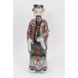Late 19th/early 20th century Chinese porcelain figure of an Immortal, polychrome decorated robe hold