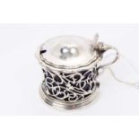 Late Victorian silver mustard of circular form, with pierced decoration and hinged domed cover, with