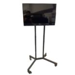 32” Samsung TV on display stand and remote controller