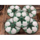 Set of six French majolica oyster plates with basket weave moulding, painted green and brown, 24cm d