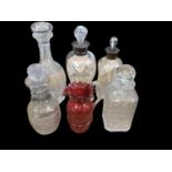 Two waisted glass decanters with silver collars, three other antique decanters and a cranberry glass